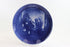 Decorative blue plate with a Christmas scene of a mother and child admiring a Christmas tree.