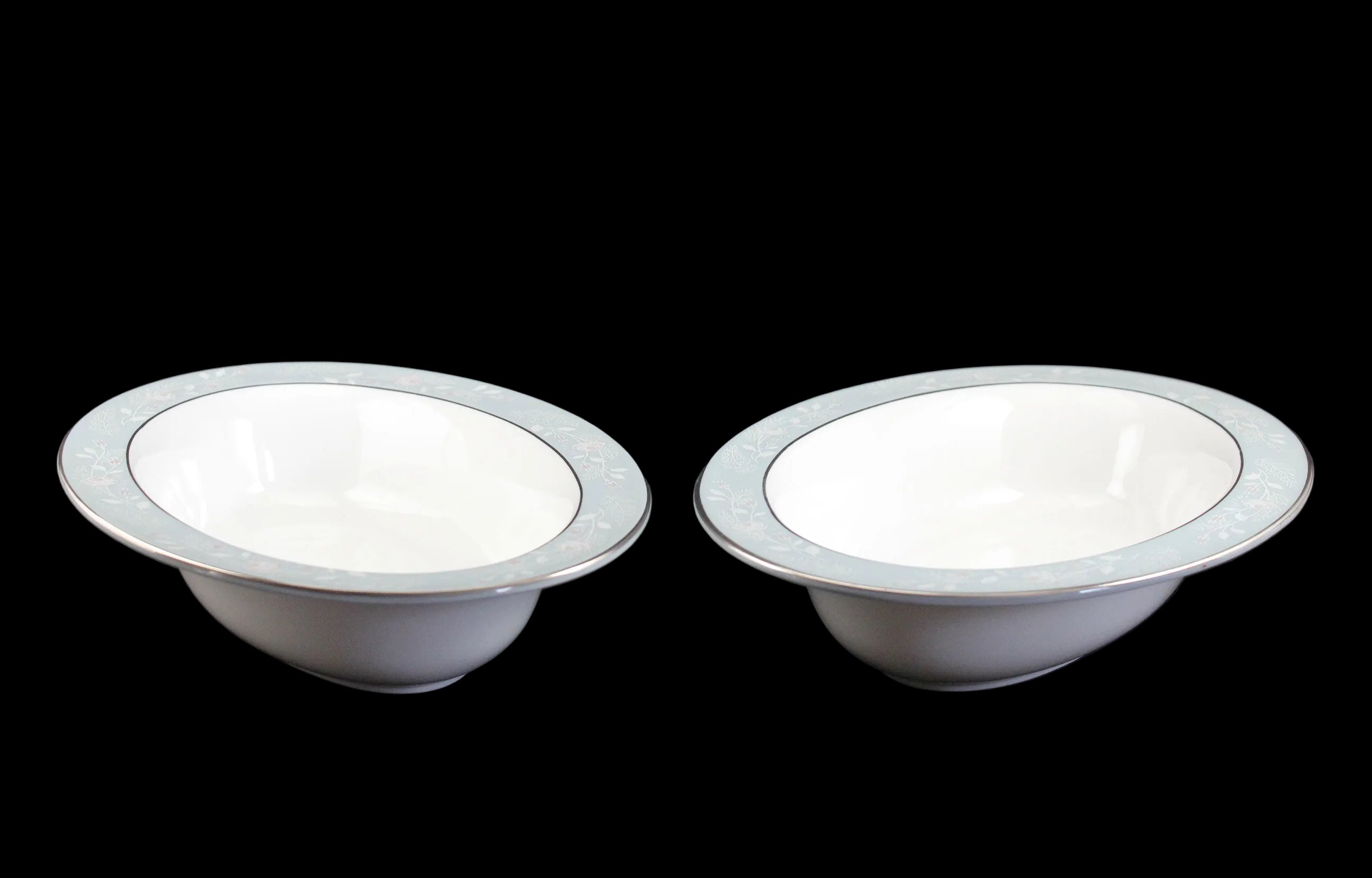 Two Royal Worcester Bridal Rose oval bowls with blue grey band and silver rims on a black background