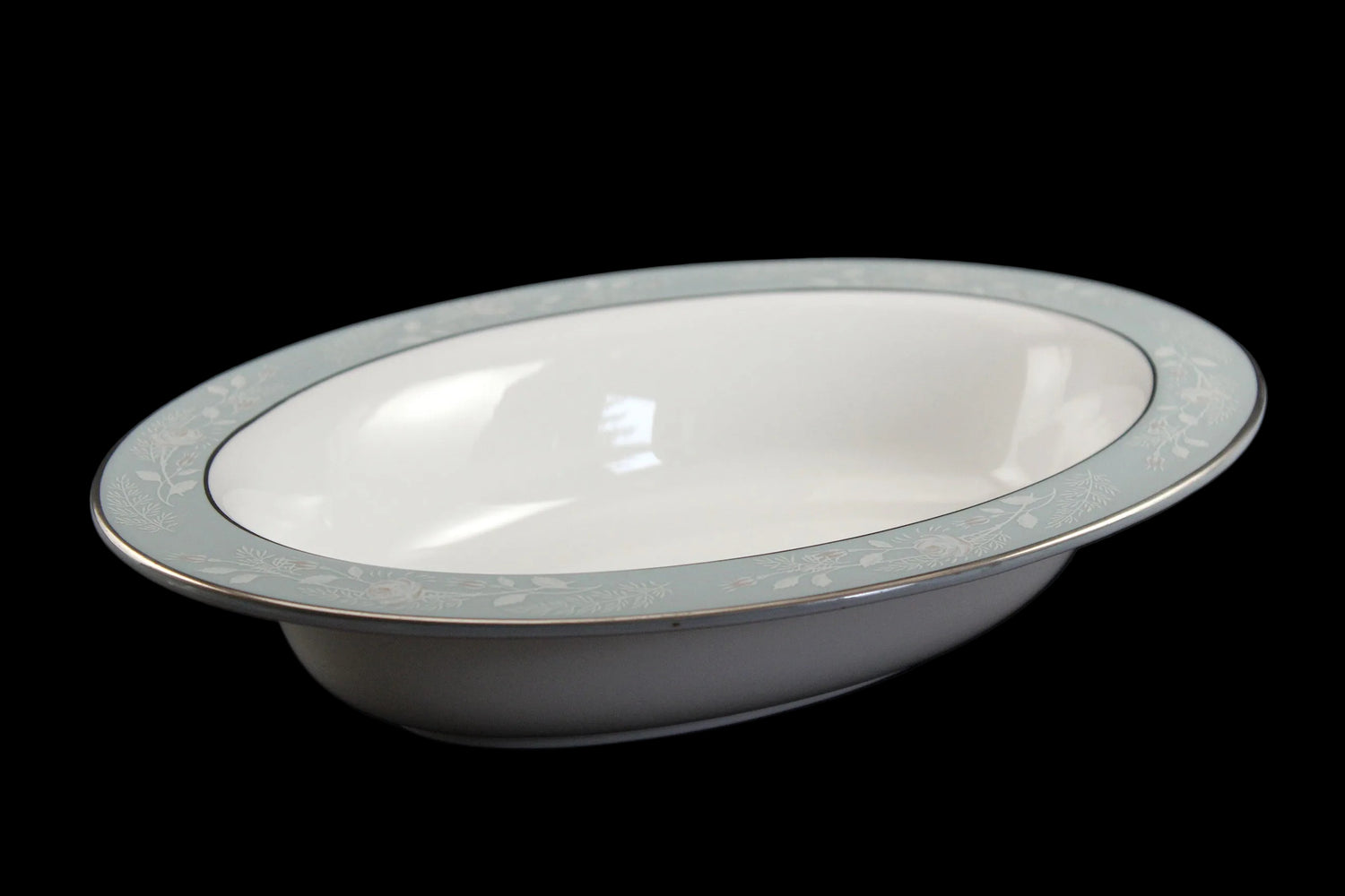 Royal Worcester Bridal Rose oval bowl with blue grey band and silver rims on a black background