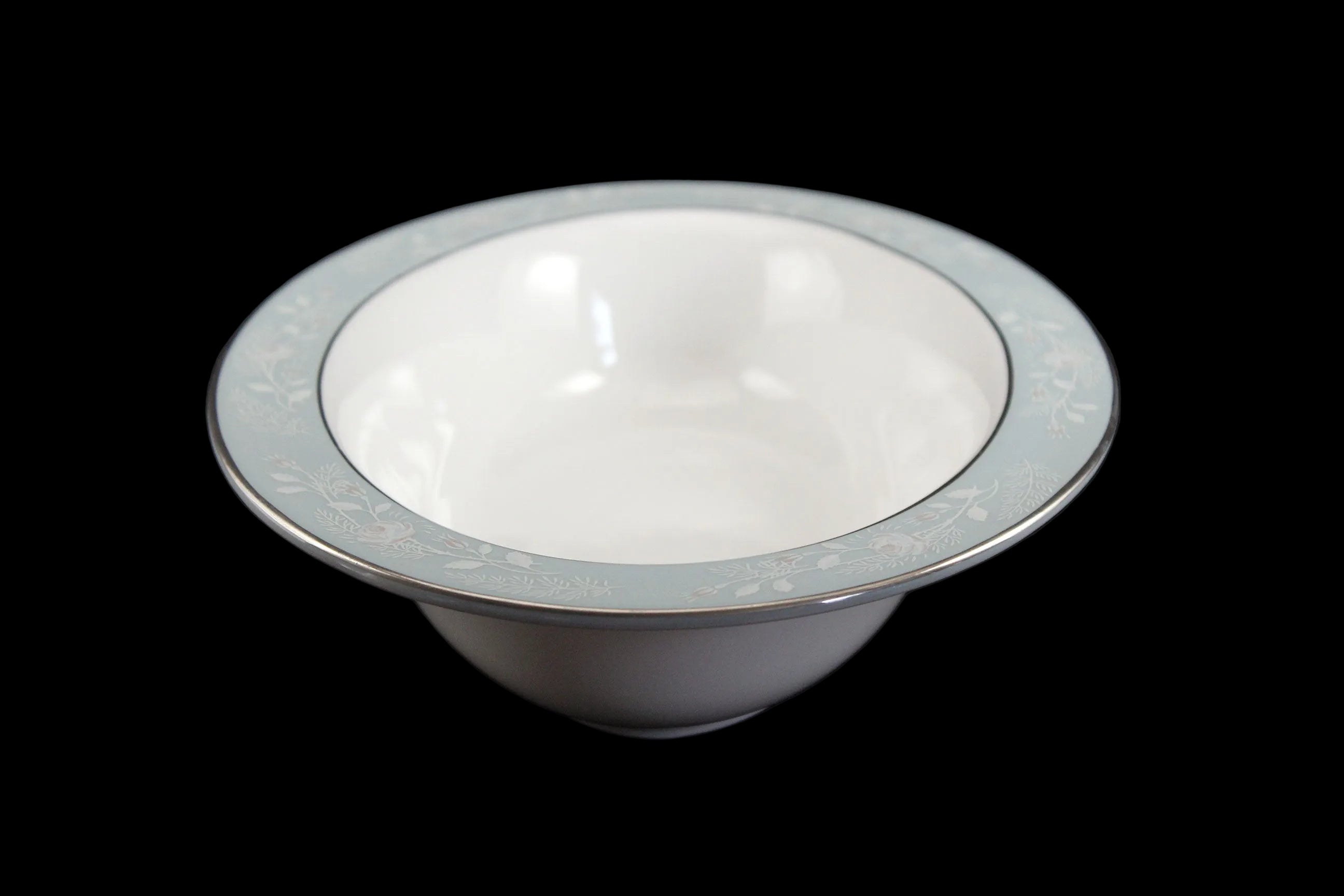Royal Worcester Bridal Rose oval bowl with blue grey band and silver rims on a black background