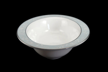 Royal Worcester Bridal Rose oval bowl with blue grey band and silver rims on a black background