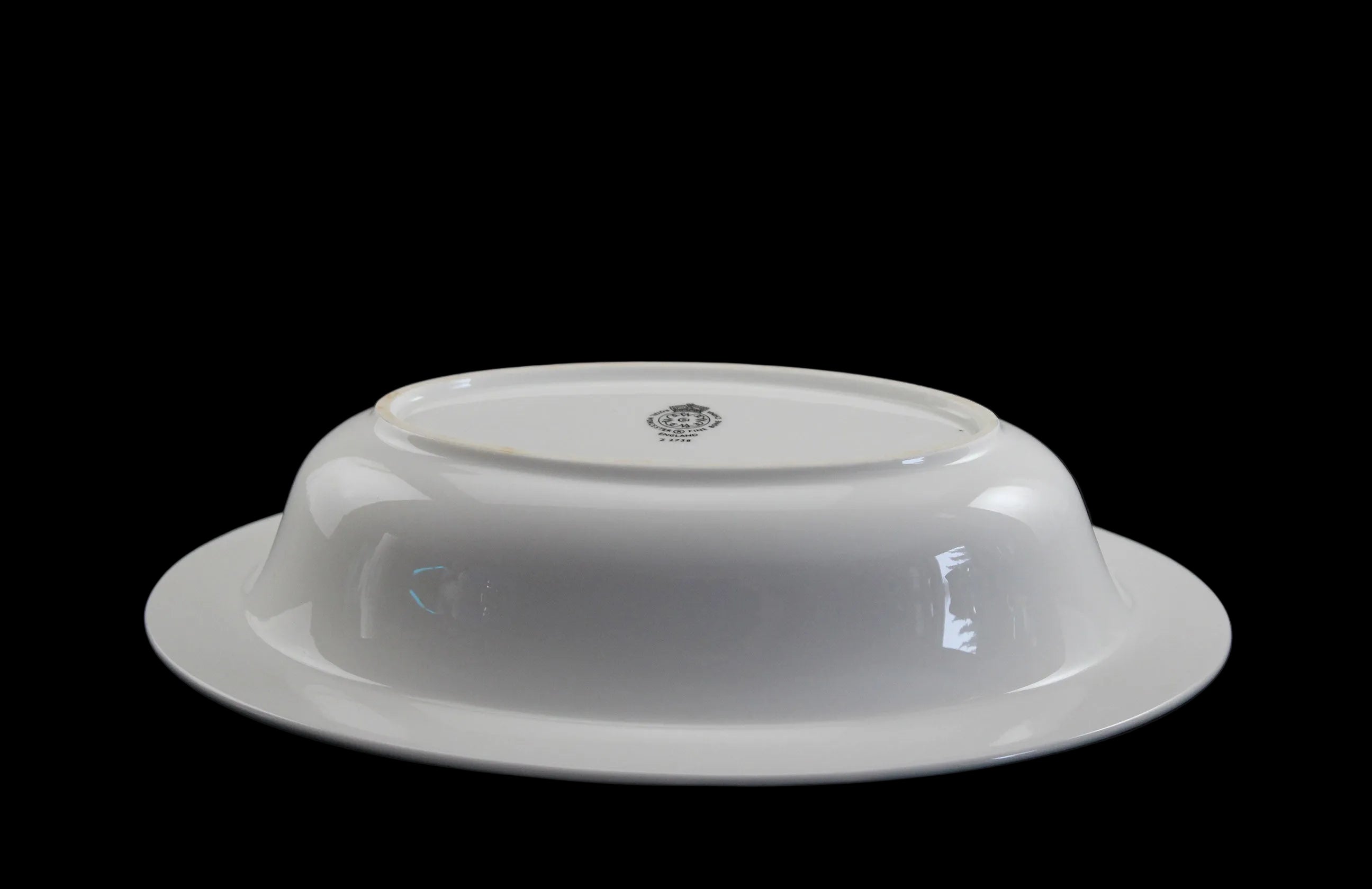 Royal Worcester Bridal Rose oval bowl with blue grey band and silver rims on a black background