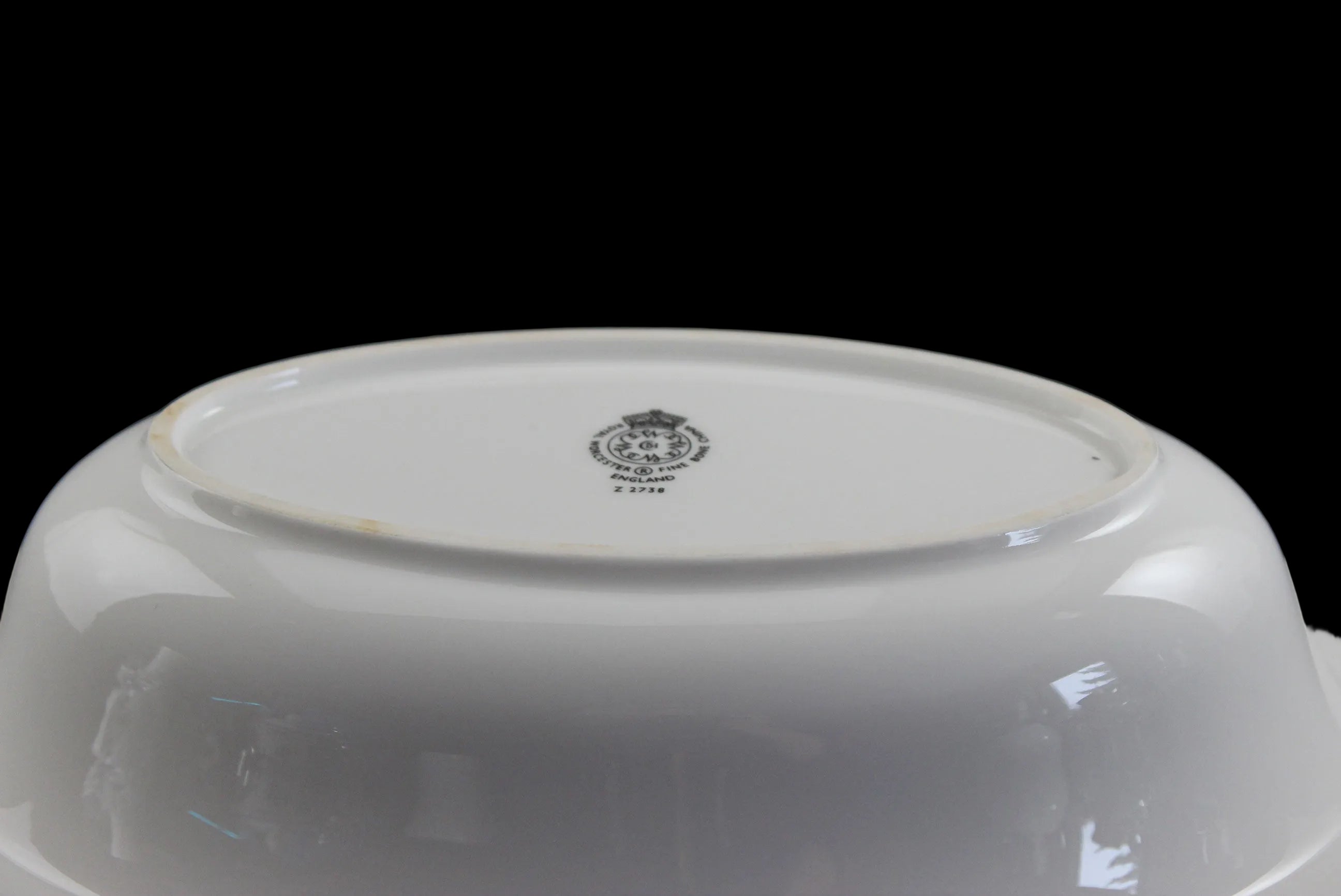 Royal Worcester Bridal Rose oval bowl with blue grey band and silver rims on a black background