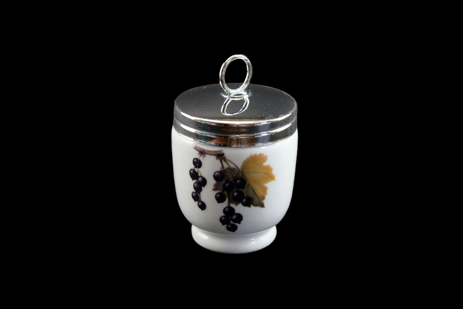 Small white egg coddler r with silver lid and black grapes design on a dark gray background