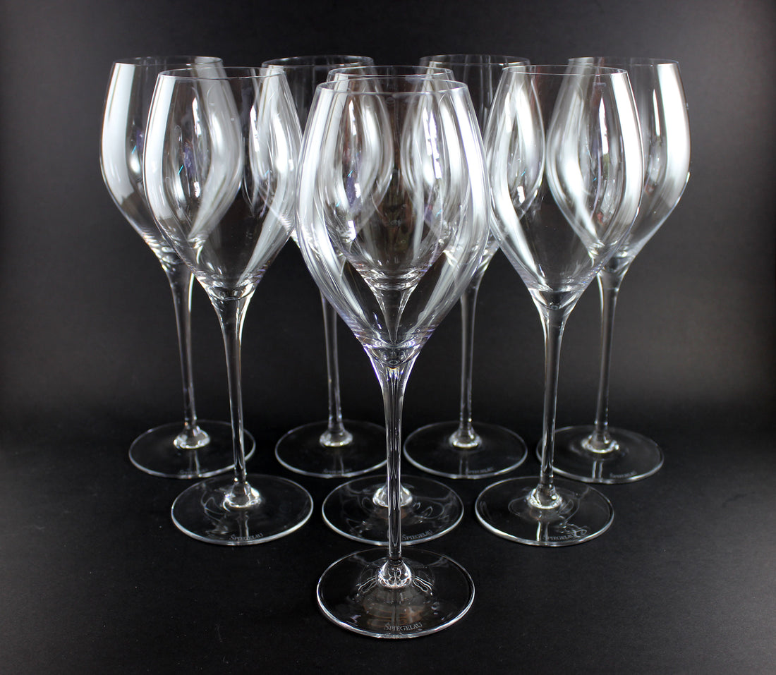 Set of clear wine glasses on a black background