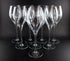 Set of clear wine glasses on a black background