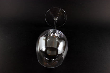 Clear wine glass on a black background