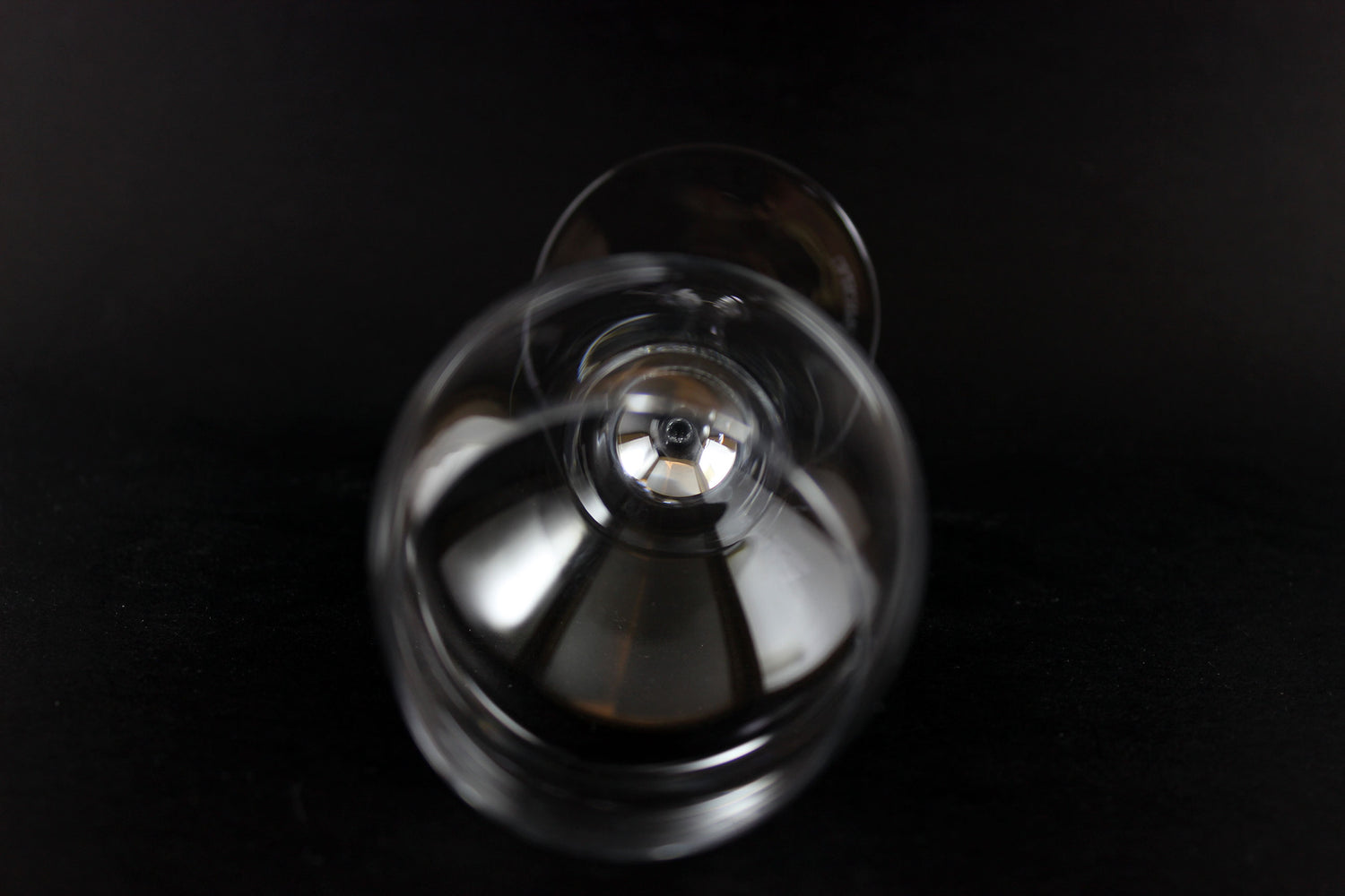 Clear wine glass on a black background