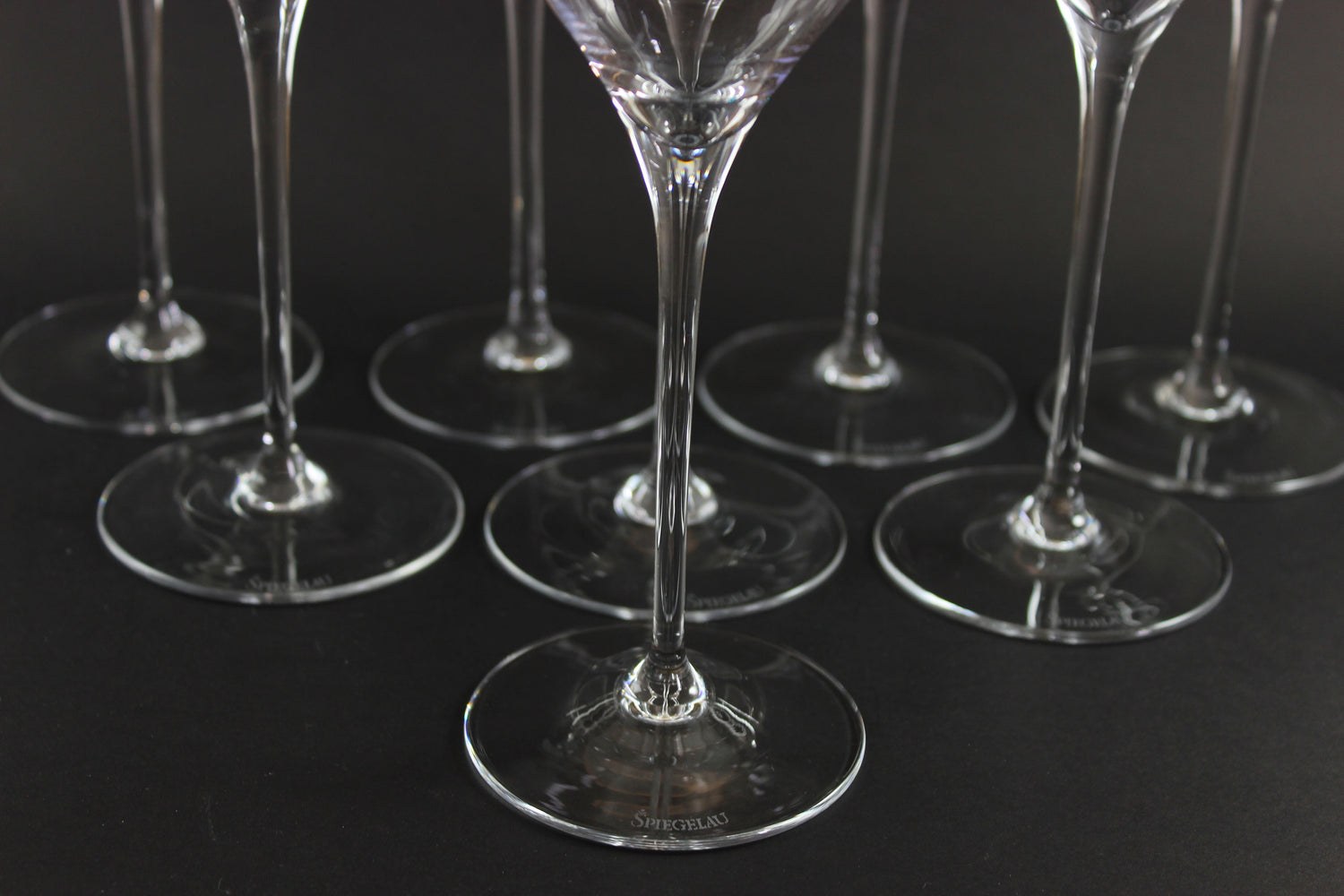Set of clear glass wine glasses on a black background