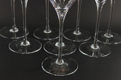 Set of clear glass wine glasses on a black background