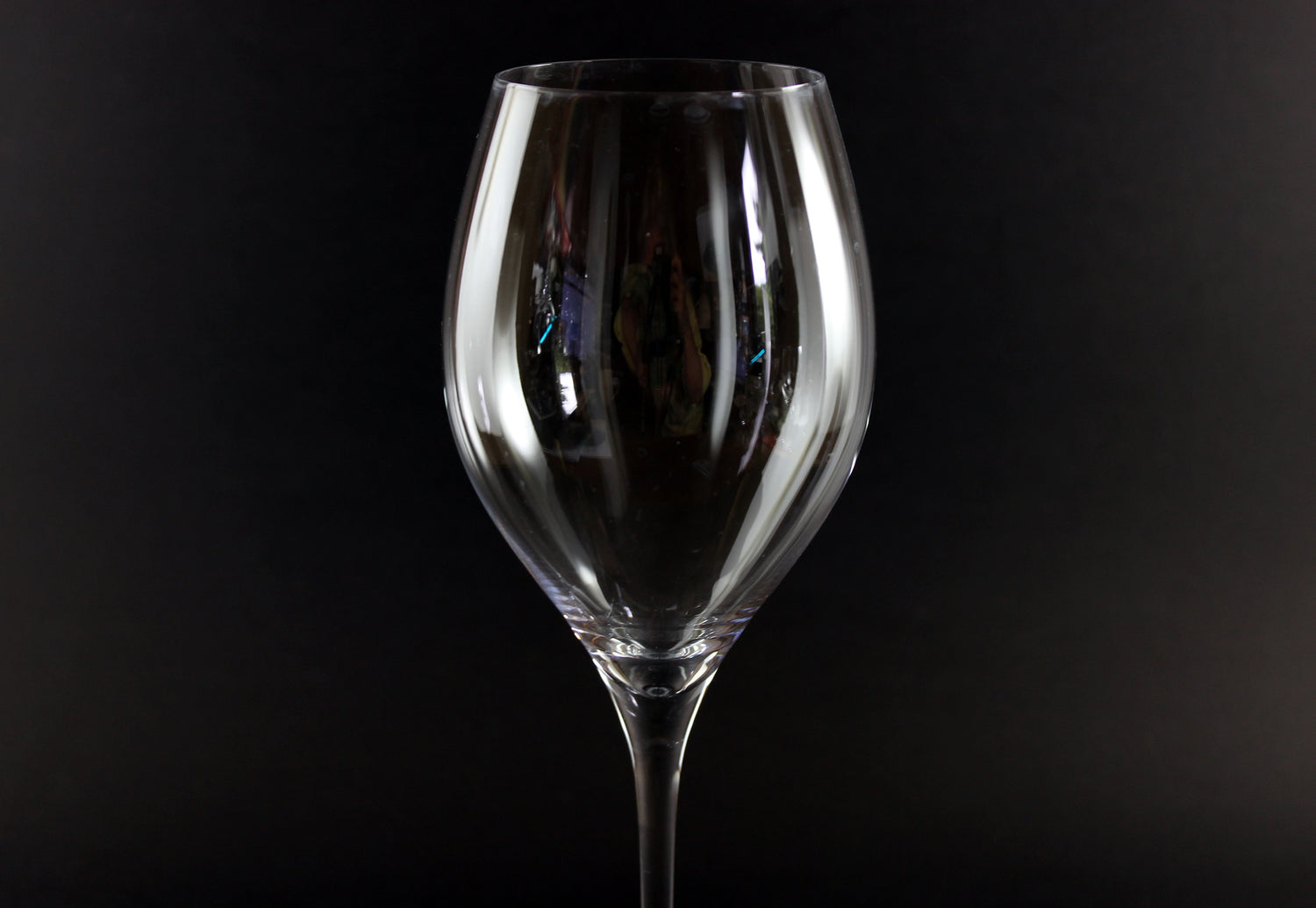 Clear wine glass on a black background