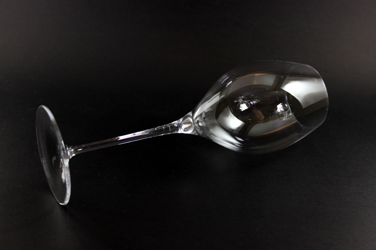 Clear wine glass on a black background