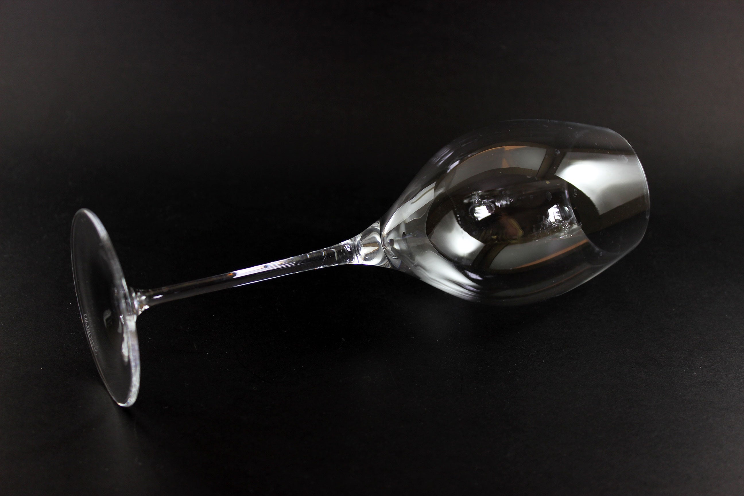 Clear wine glass on a black background