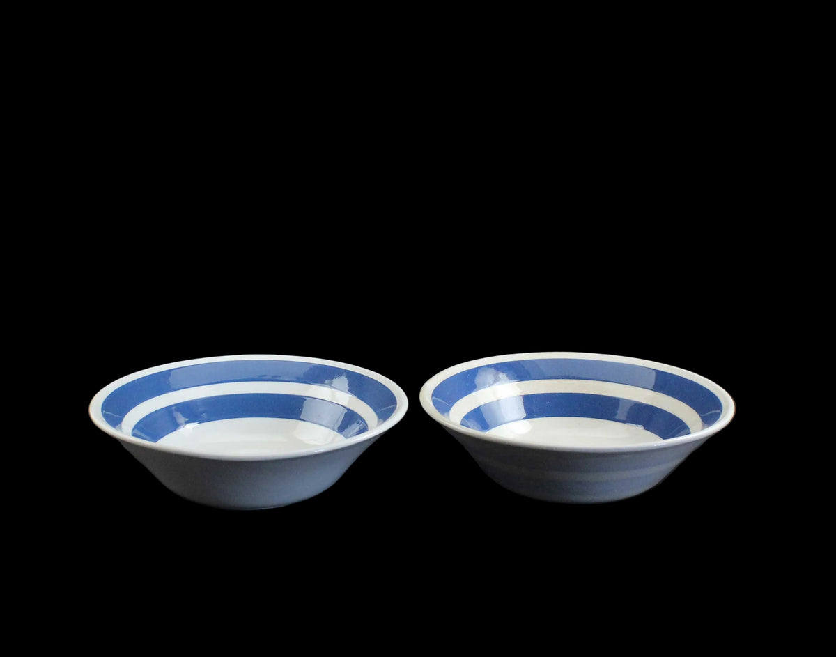 White ironstone cereal bowl with blue stripes in Cornishware style.