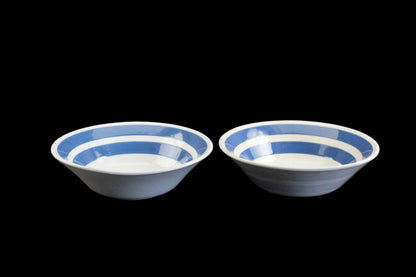 White ironstone cereal bowl with blue stripes in Cornishware style.