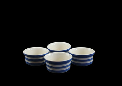 Set of four blue and white striped ceramic bowls on a black background