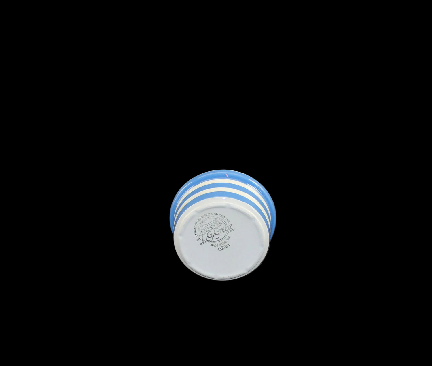 Blue and white striped small bowl on a dark surface