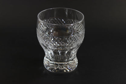 Clear glass with diamond cut pattern on a black background