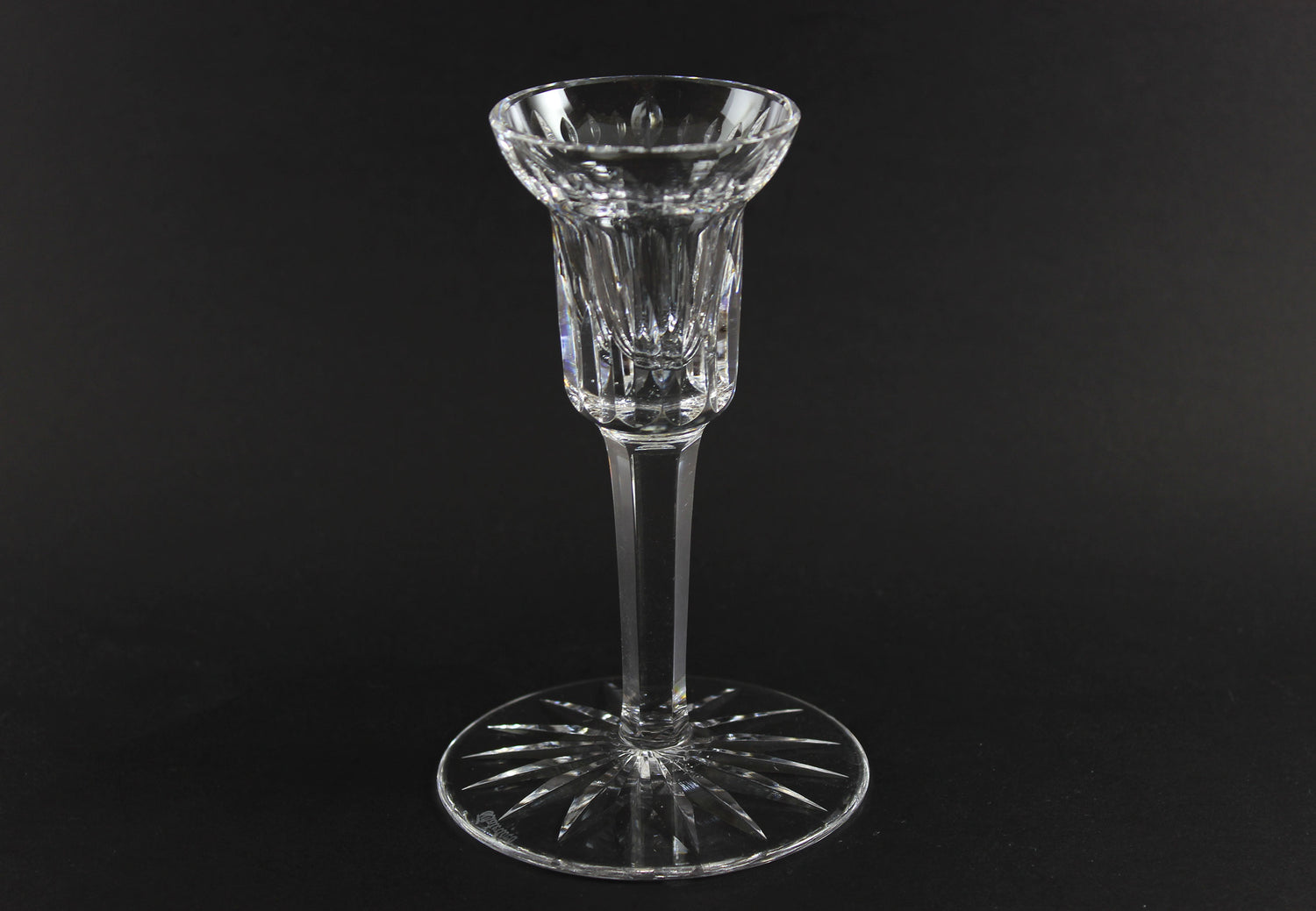 Clear crystal candlestick on a black background