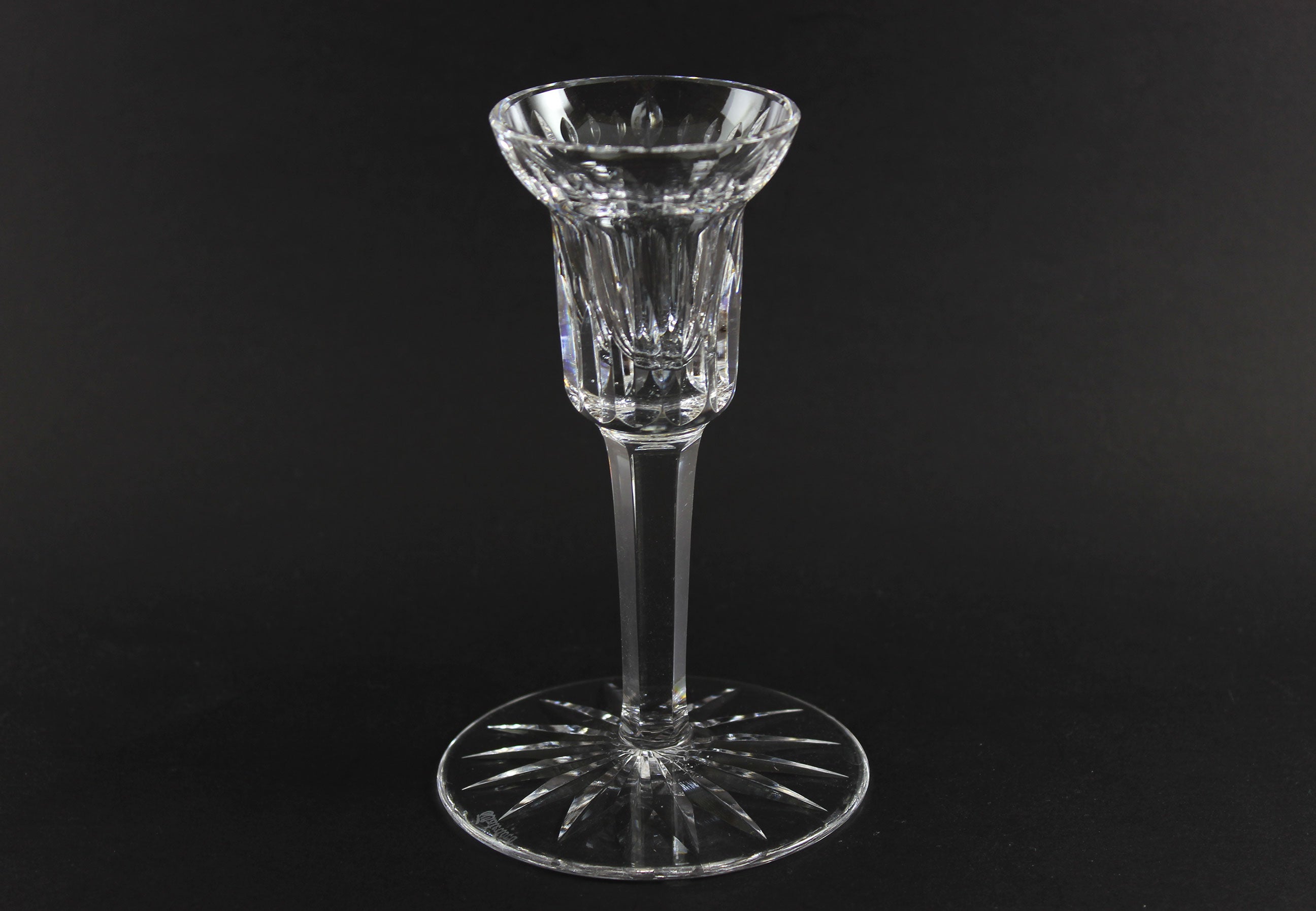 Clear crystal candlestick on a black background