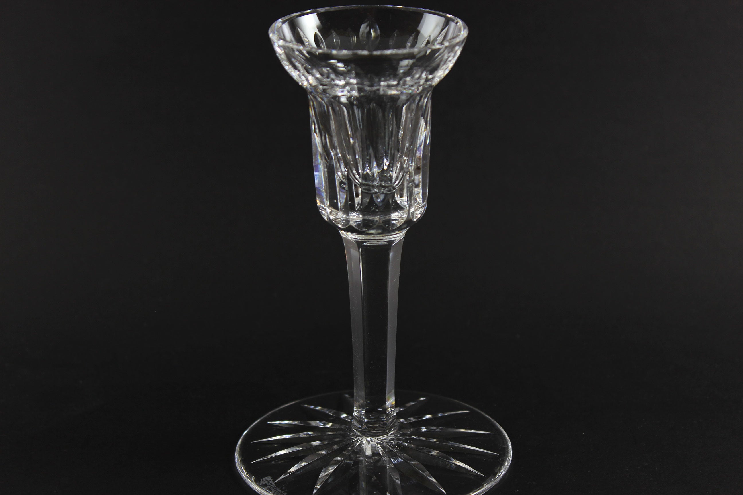 Clear crystal candlestick on a black background