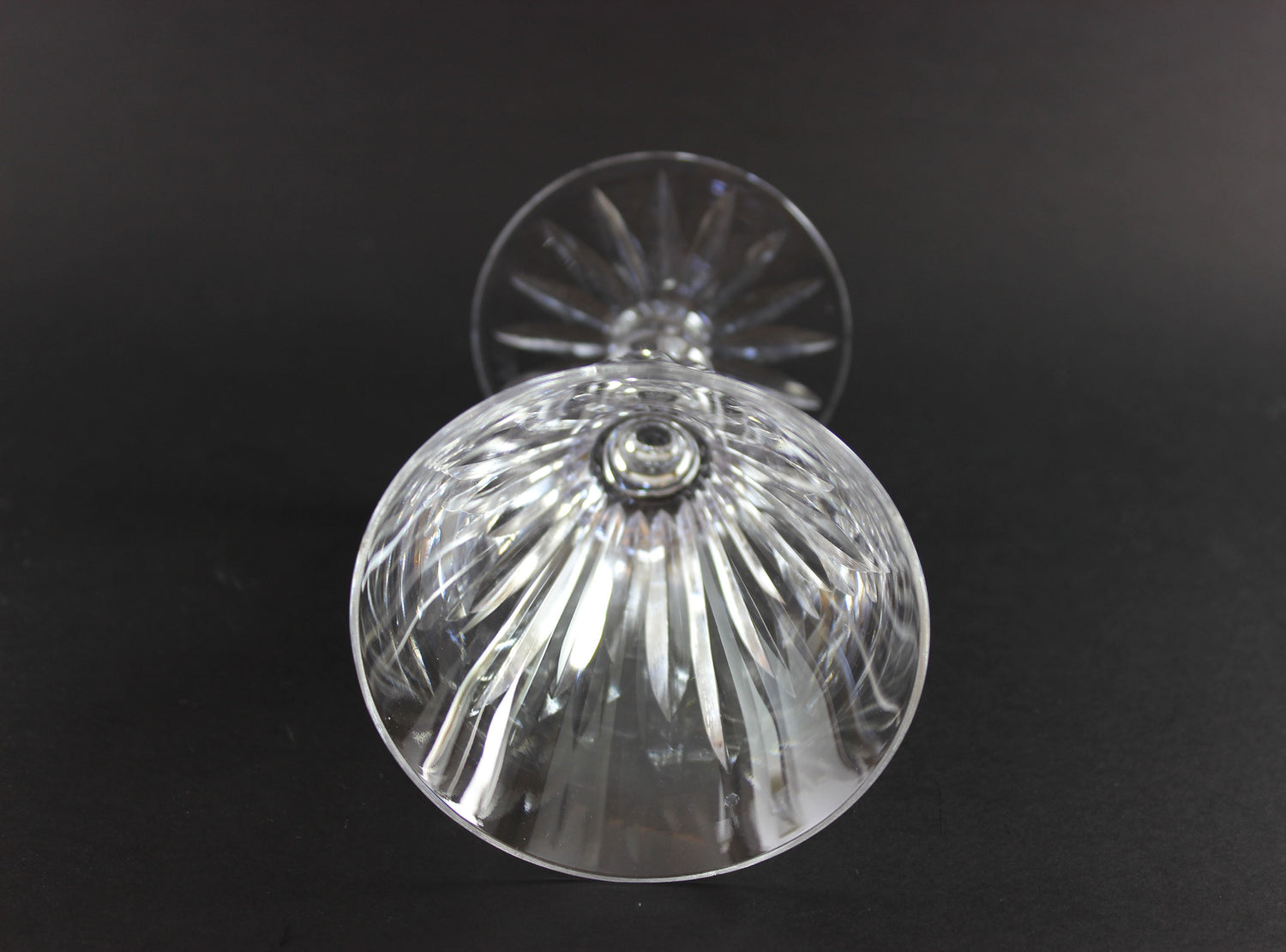 Cut ut crystal  goblet with intricate designs on a black background