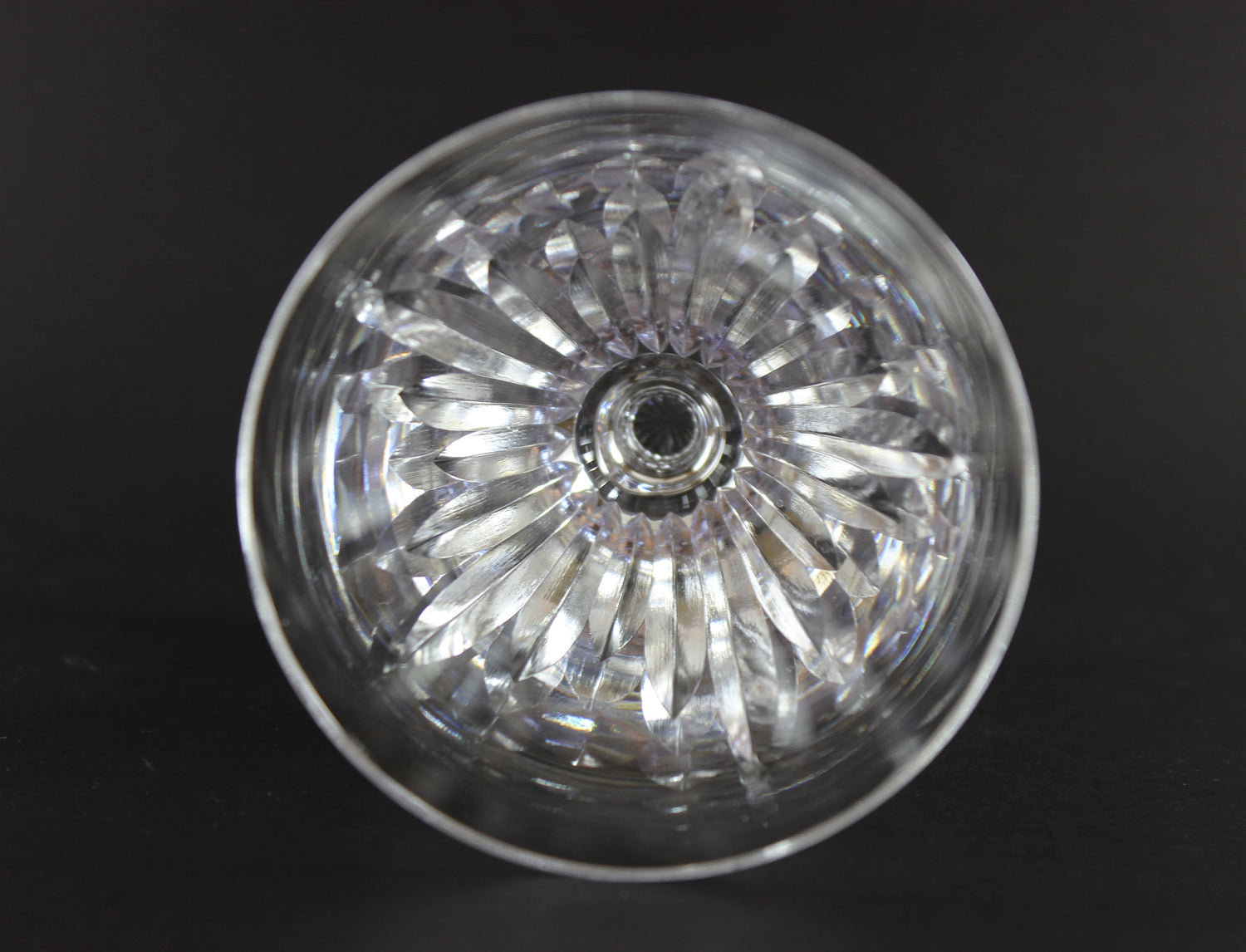 Cut crystal  goblet with intricate designs on a black background