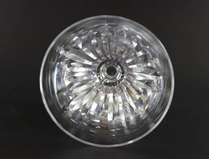 Cut crystal  goblet with intricate designs on a black background