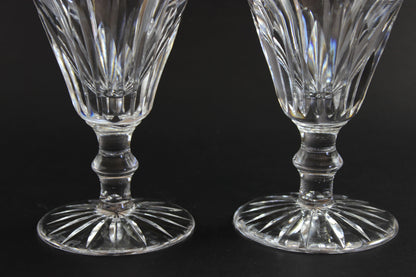 Two cut crystal  goblets with intricate designs on a black background