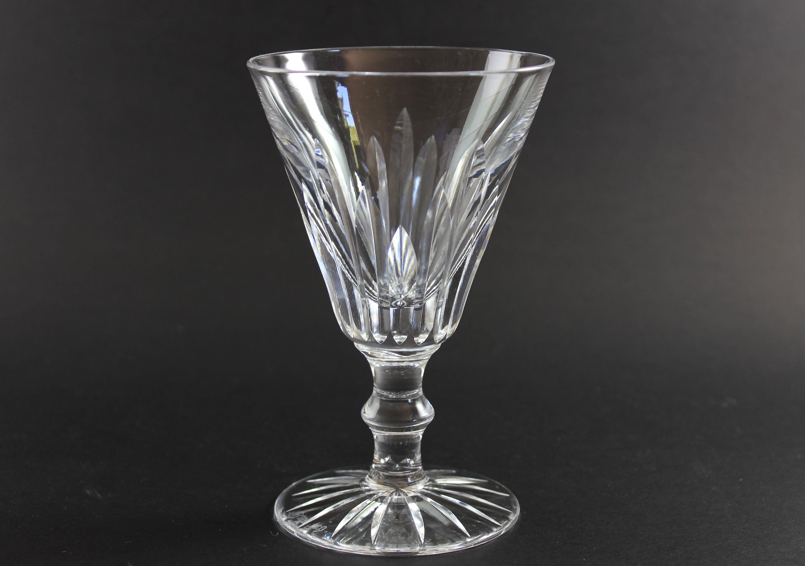Cut crystal  goblet with intricate designs on a black background