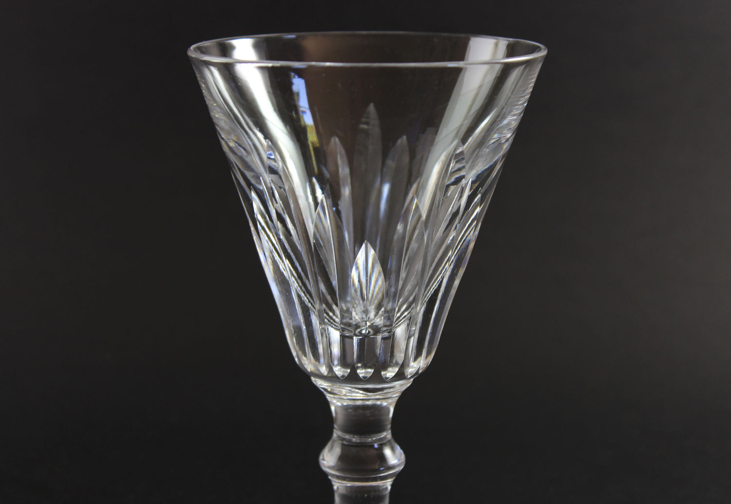 Cut crystal  goblet with intricate designs on a black background