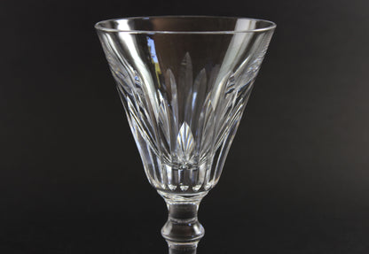 Cut crystal  goblet with intricate designs on a black background