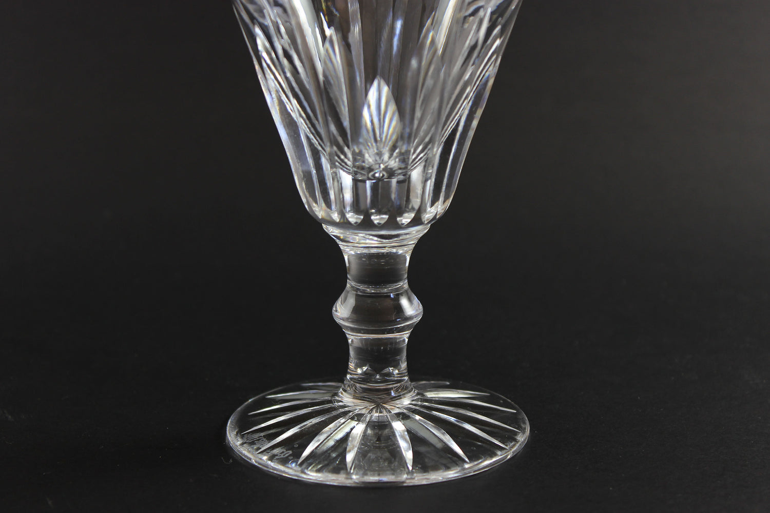 Cut crystal goblet with intricate design on a black background