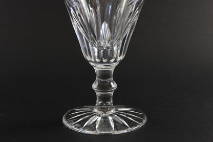 Cut crystal goblet with intricate design on a black background