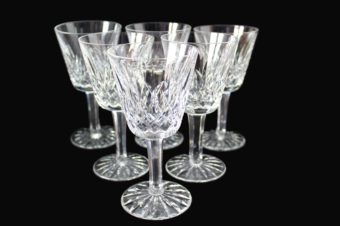 Set of six crystal wine glasses on a dark background