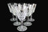 Set of six crystal wine glasses on a dark background