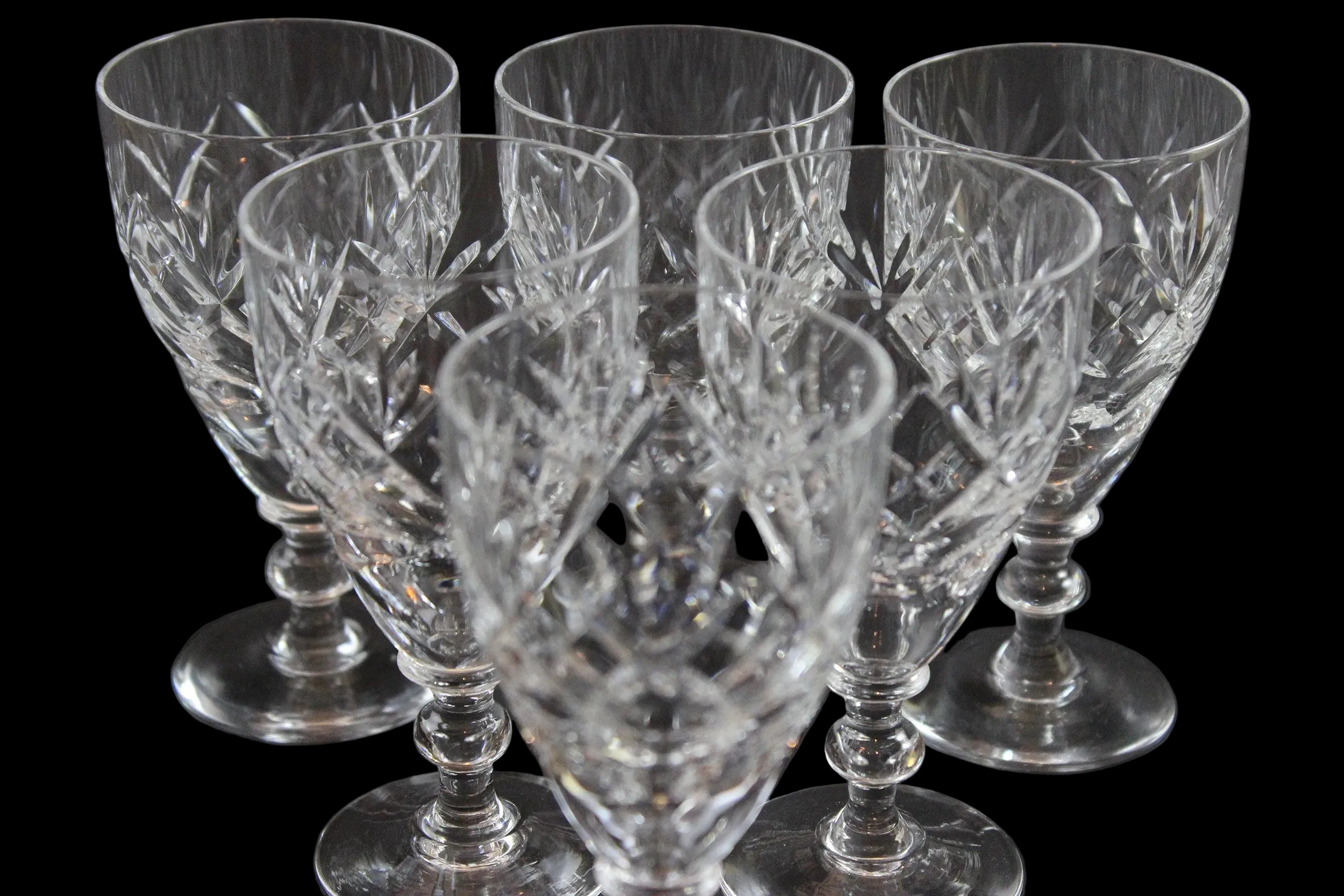Set of six crystal sherry or port glasses on a dark background