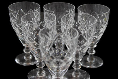 Set of six crystal sherry or port glasses on a dark background