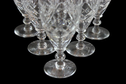 Set of six crystal sherry or port glasses on a dark background