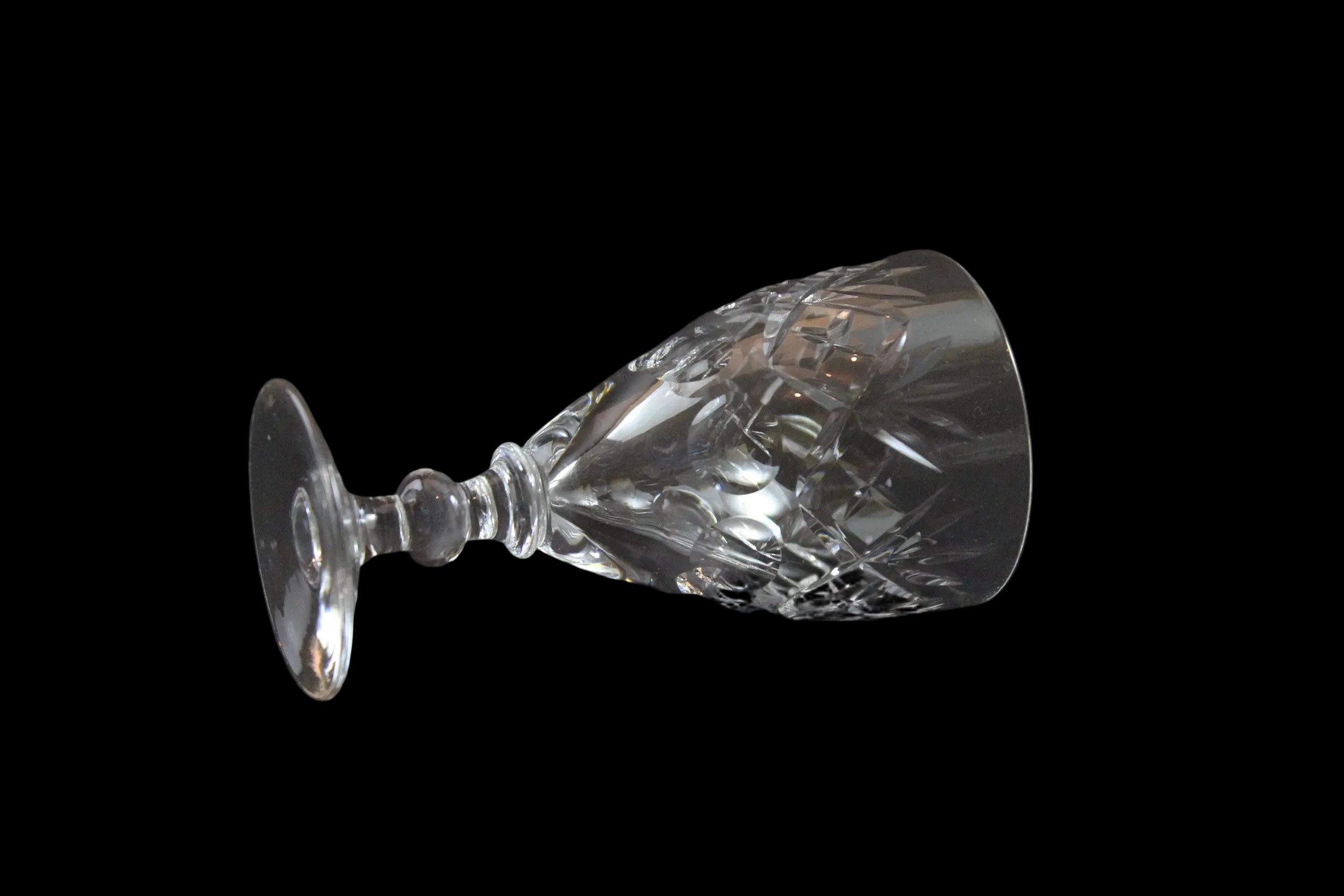 Set of six crystal sherry or port glasses on a dark background