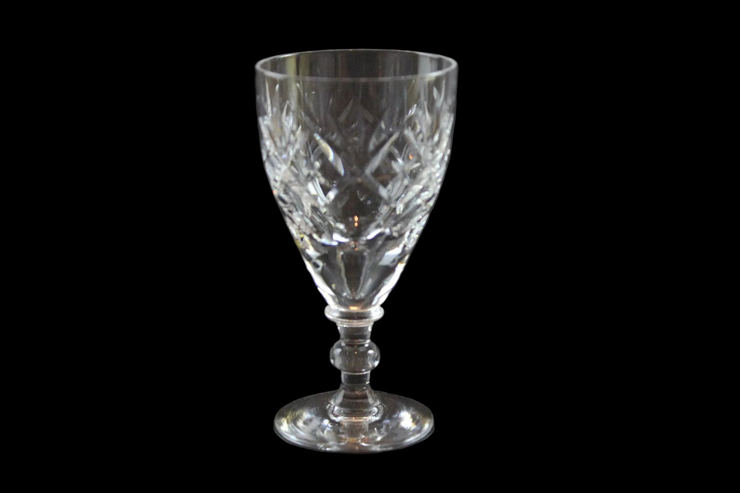 Set of six crystal sherry or port glasses on a dark background