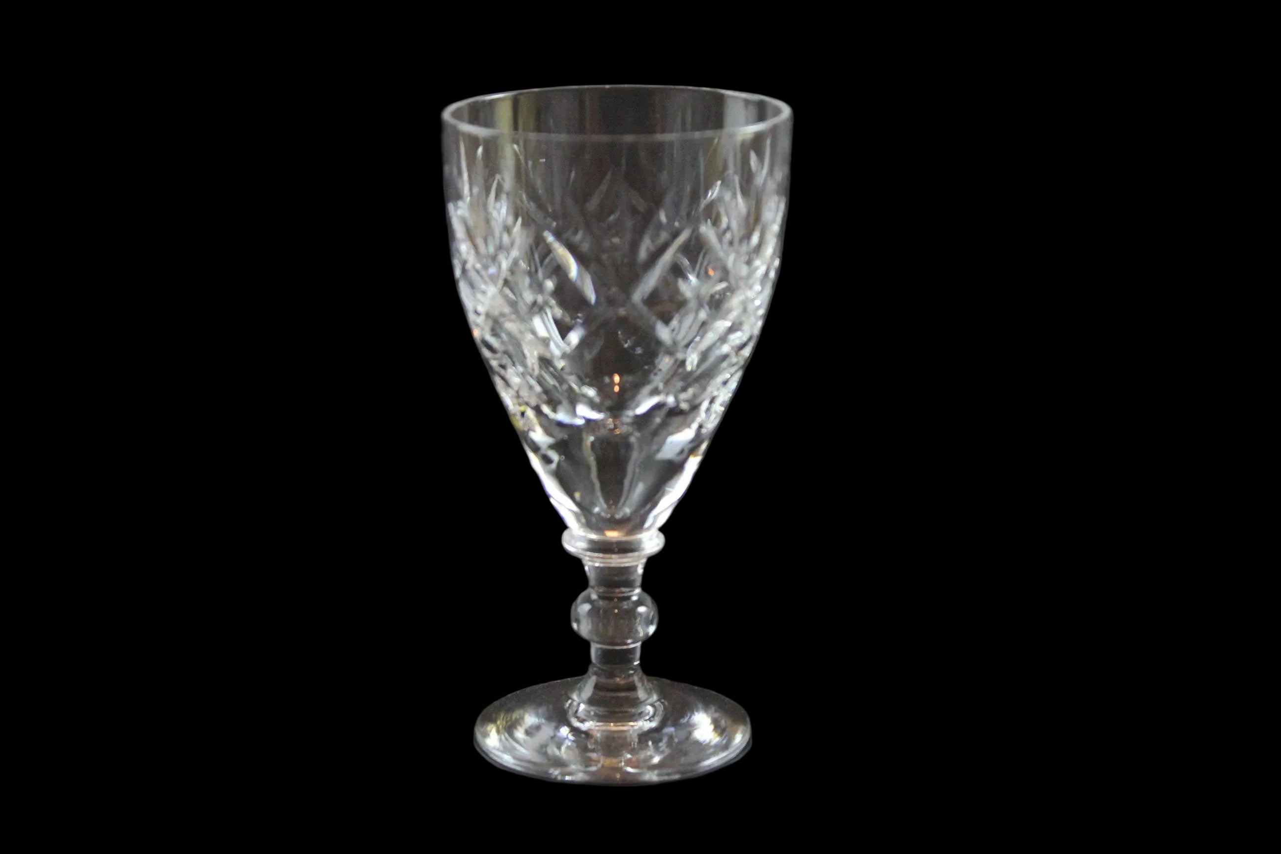 Set of six crystal sherry or port glasses on a dark background
