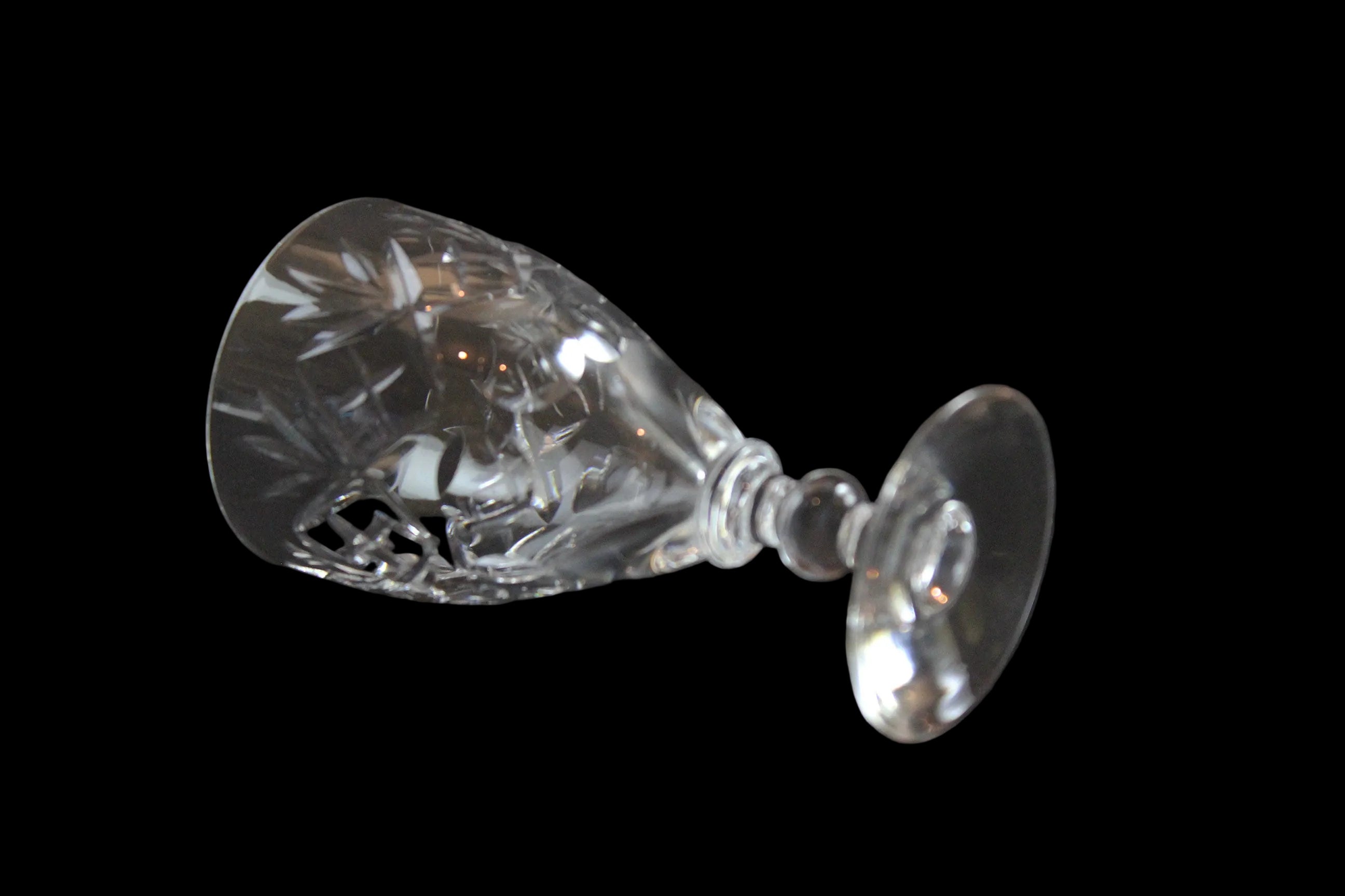 Set of six crystal sherry or port glasses on a dark background