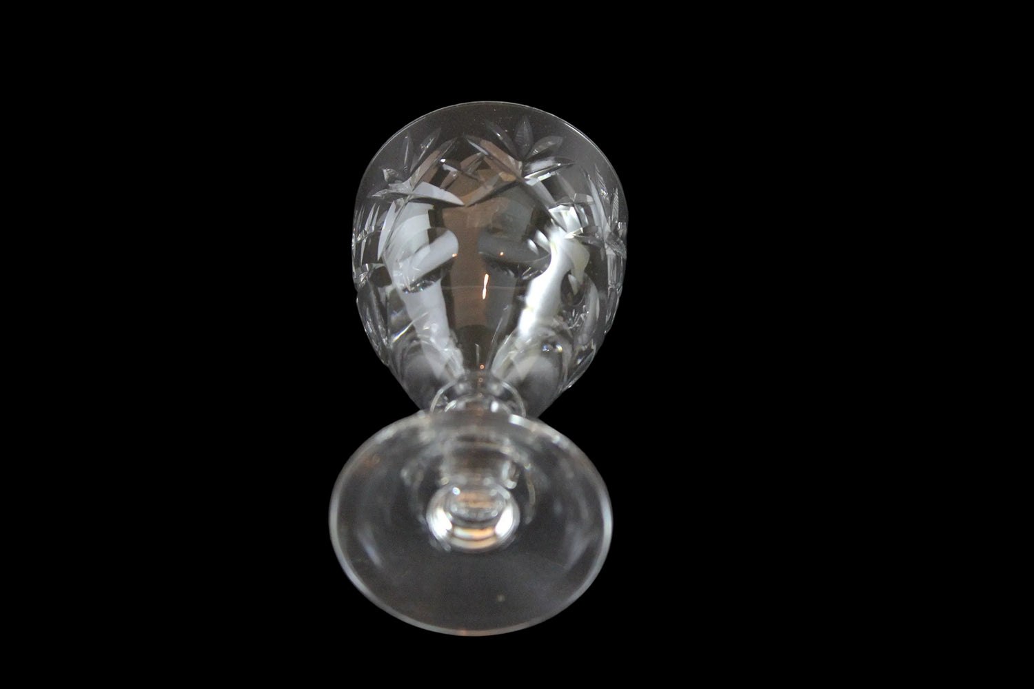 Set of six crystal sherry or port glasses on a dark background