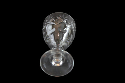 Set of six crystal sherry or port glasses on a dark background